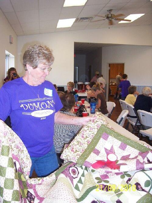 Wren Owen examining a quilt